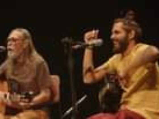 May be an image of 2 people, beard, people sitting, people playing musical instruments, guitar and indoor